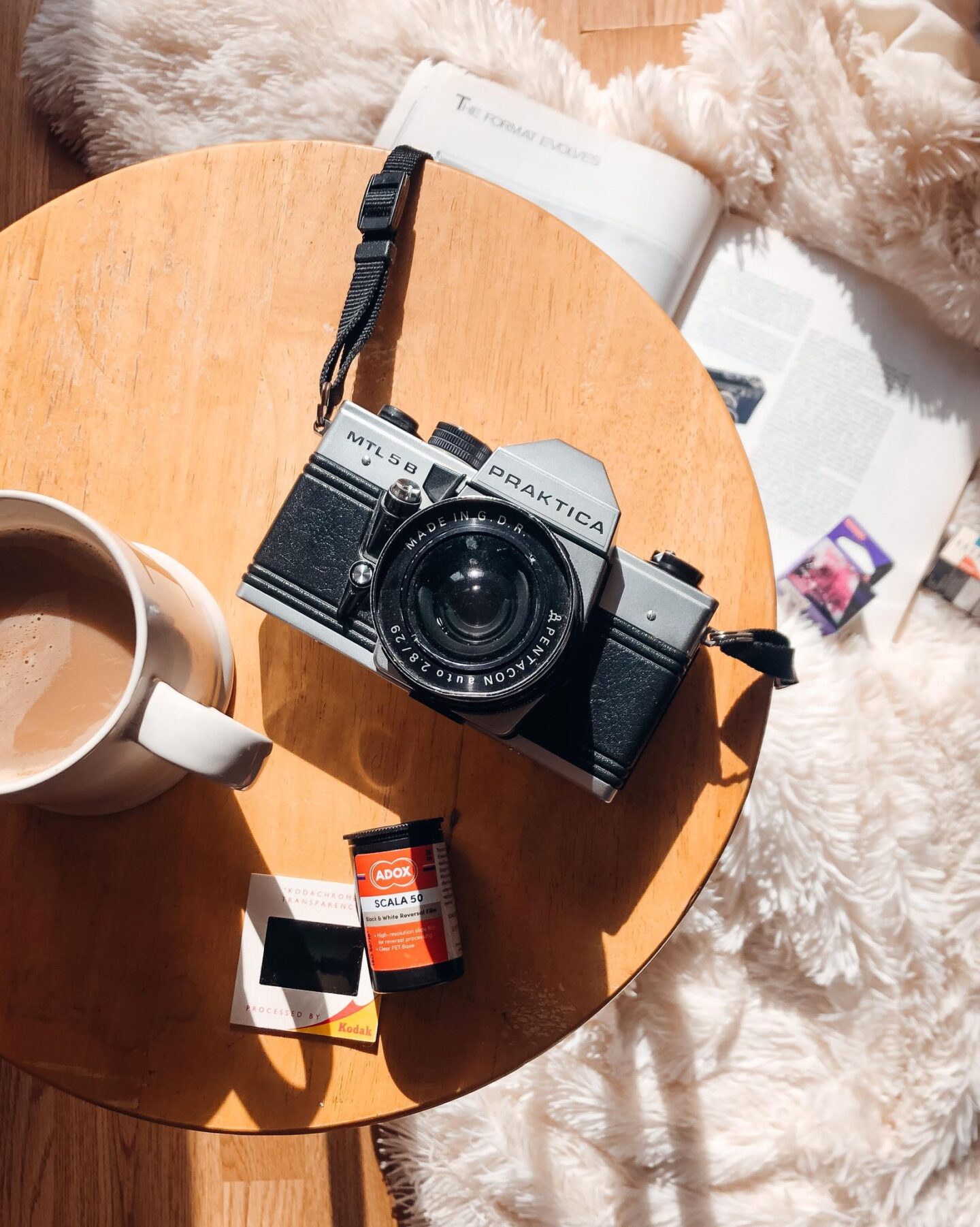 Praktica film camera from above next to roll of film